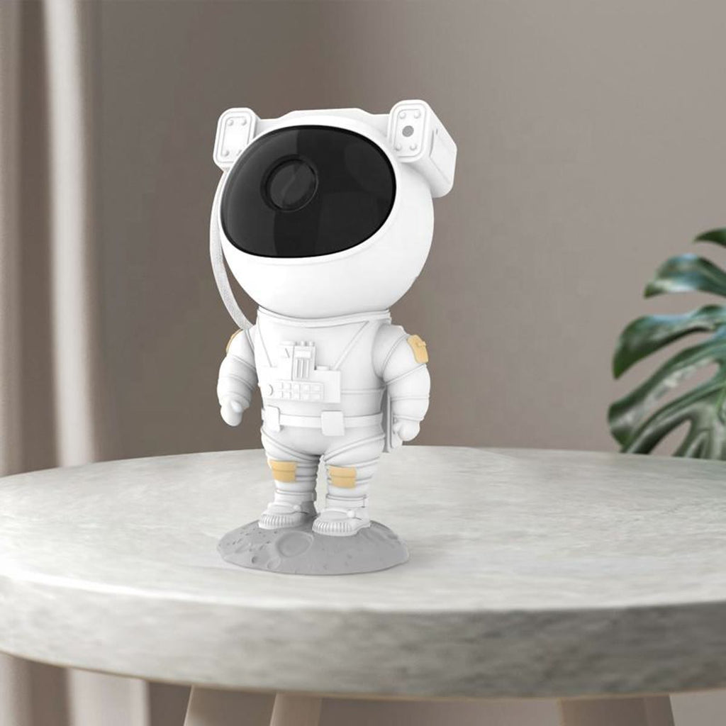 Astronaut-projektoren på en marmorbenk med en plante bak