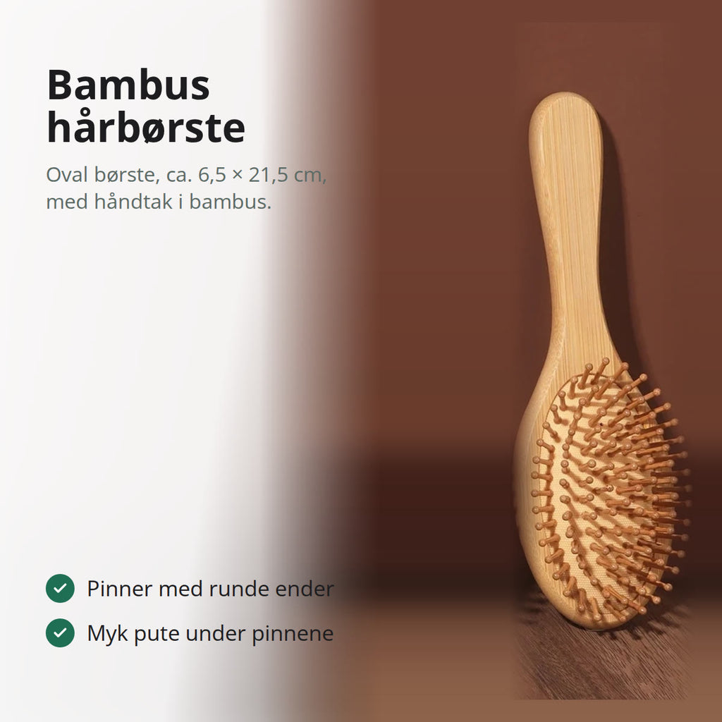 Oval bambus hårbørste med pinner med runde ender, lent mot en brun vegg