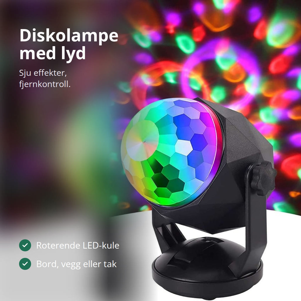 Diskolampe som kaster fargede lysprikker i et mørkt rom