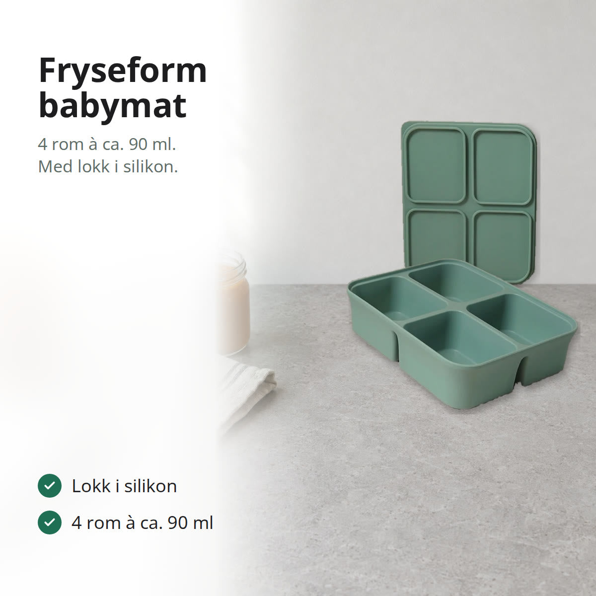 Grønn fryseform til babymat i silikon med fire rom og lokk på en kjøkkenbenk