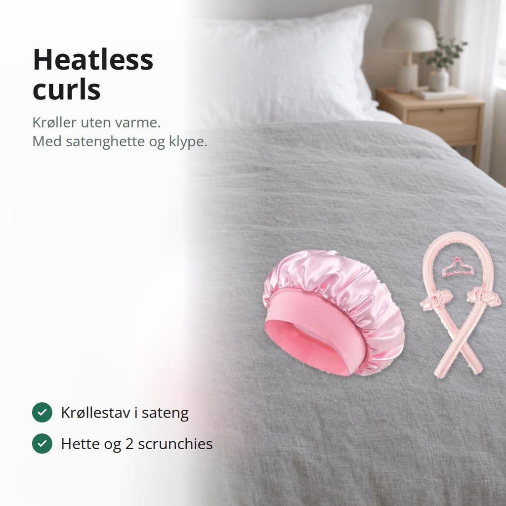 Heatless curls-sett i rosa sateng med krøllestav, hette, scrunchies og hårklype på en seng