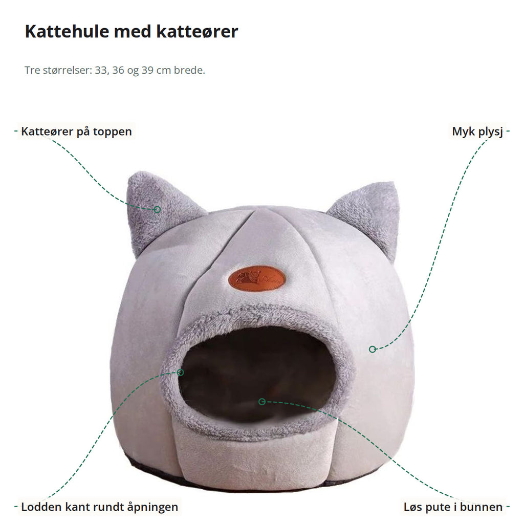Lys grå kattehule merket med katteører, myk plysj, lodden kant rundt åpningen og løs pute i bunnen
