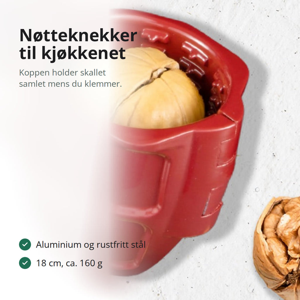 Rød håndholdt nøtteknekker i metall med en valnøtt i den koppformede holderen