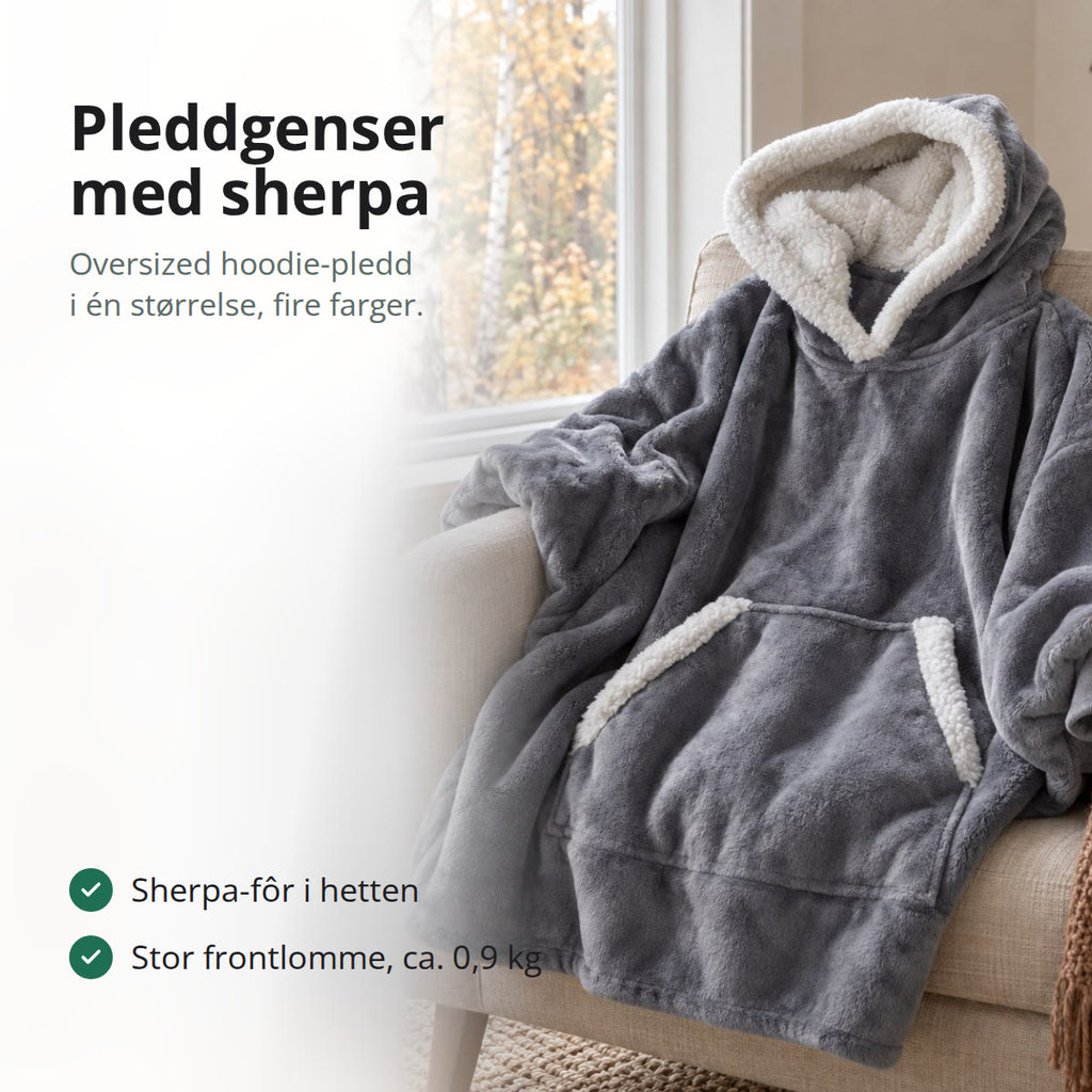 Grå pleddgenser med sherpa-fôr i hetten og stor frontlomme, lagt over en beige lenestol ved et vindu