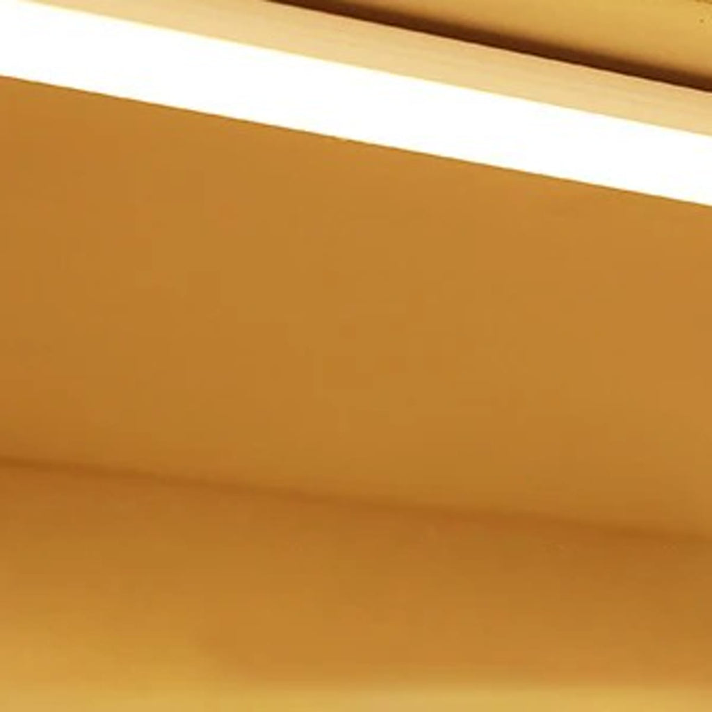 LED-listen montert under en hylle, varmt lys på veggen