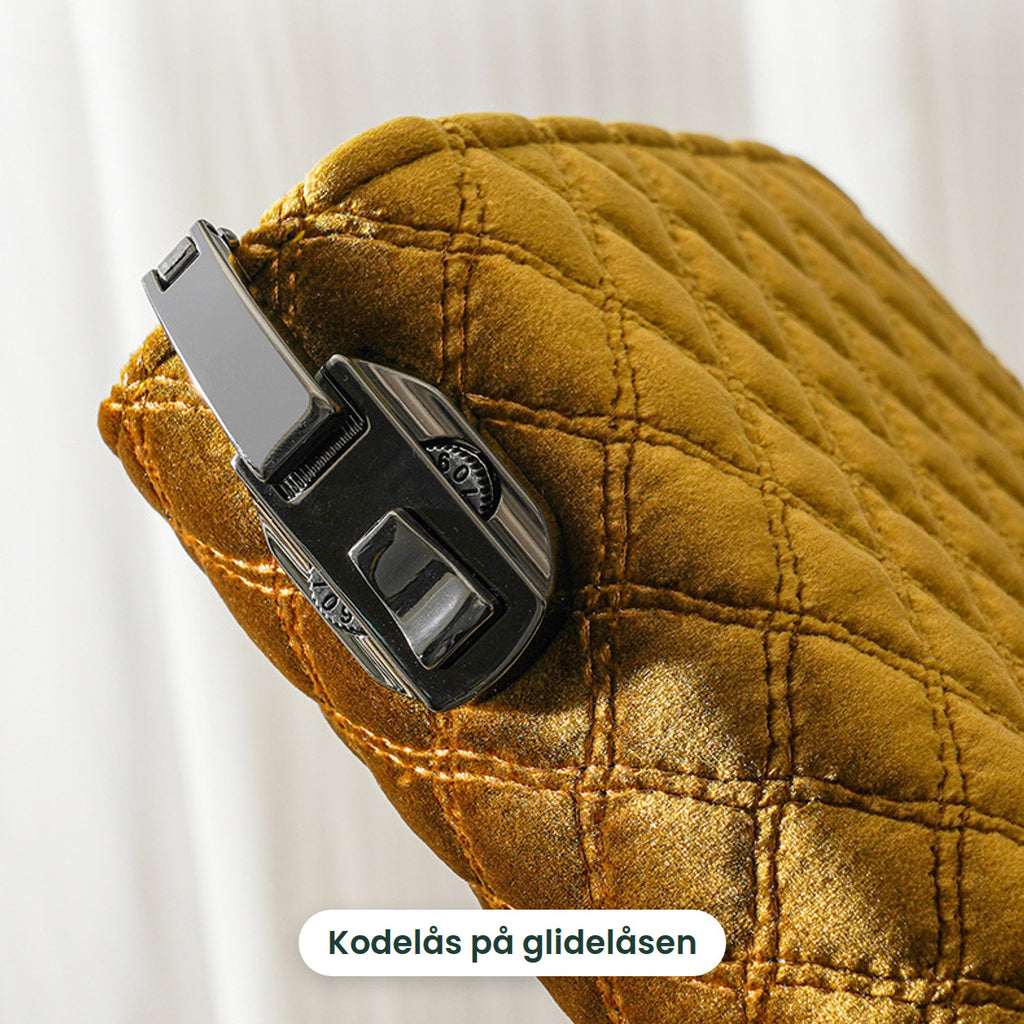 Kodelåsen på glidelåsen til smykkeboken i gull
