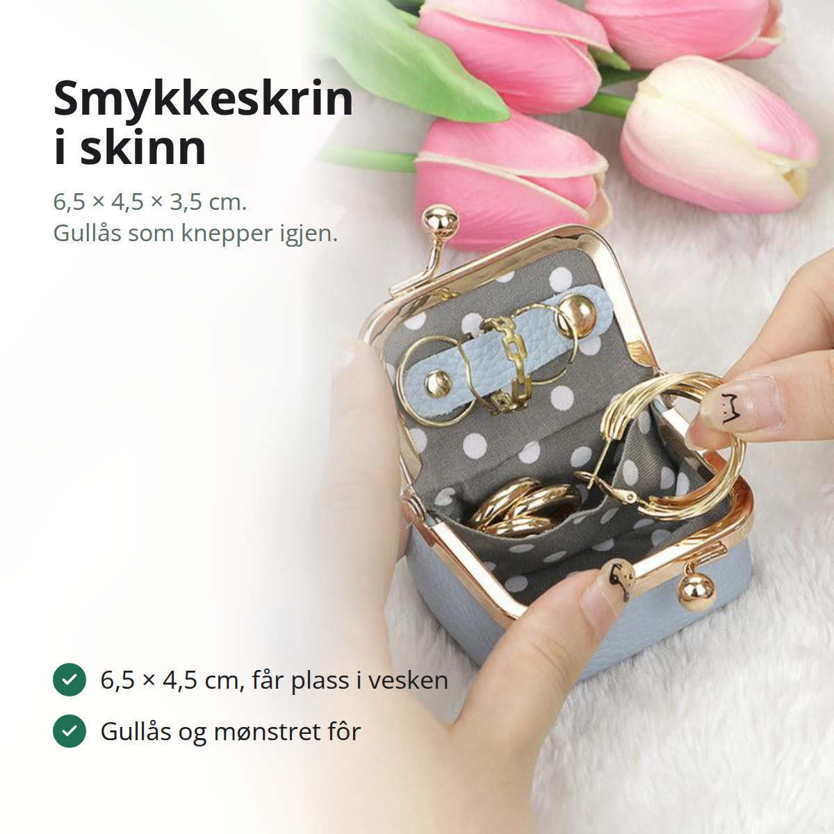 Lite smykkeskrin i skinn med gullås, stående på en marmorbenk ved siden av en ring