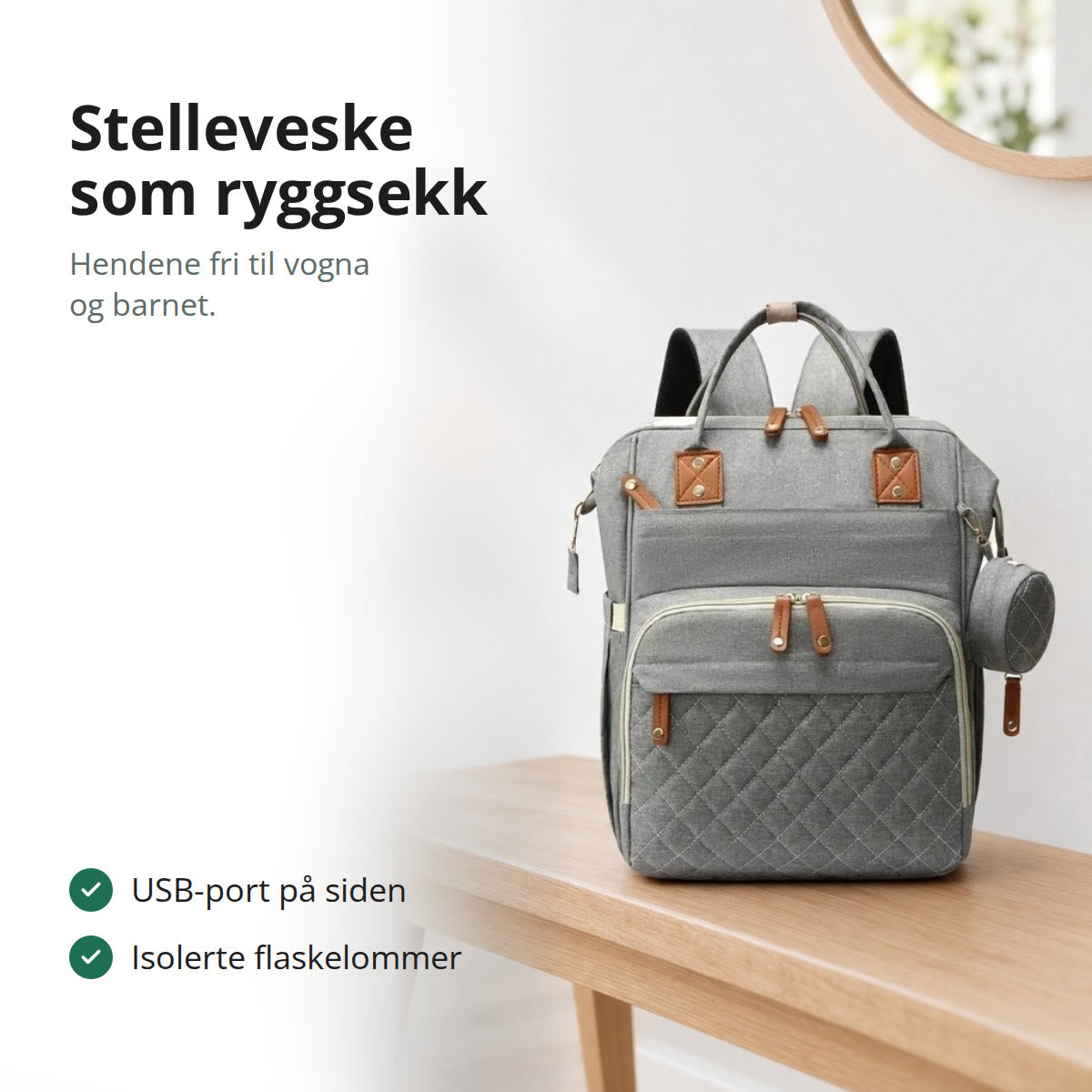 Stelleveske som ryggsekk i grått med quiltet frontlomme og rund smokklomme, stående på en benk i en lys gang