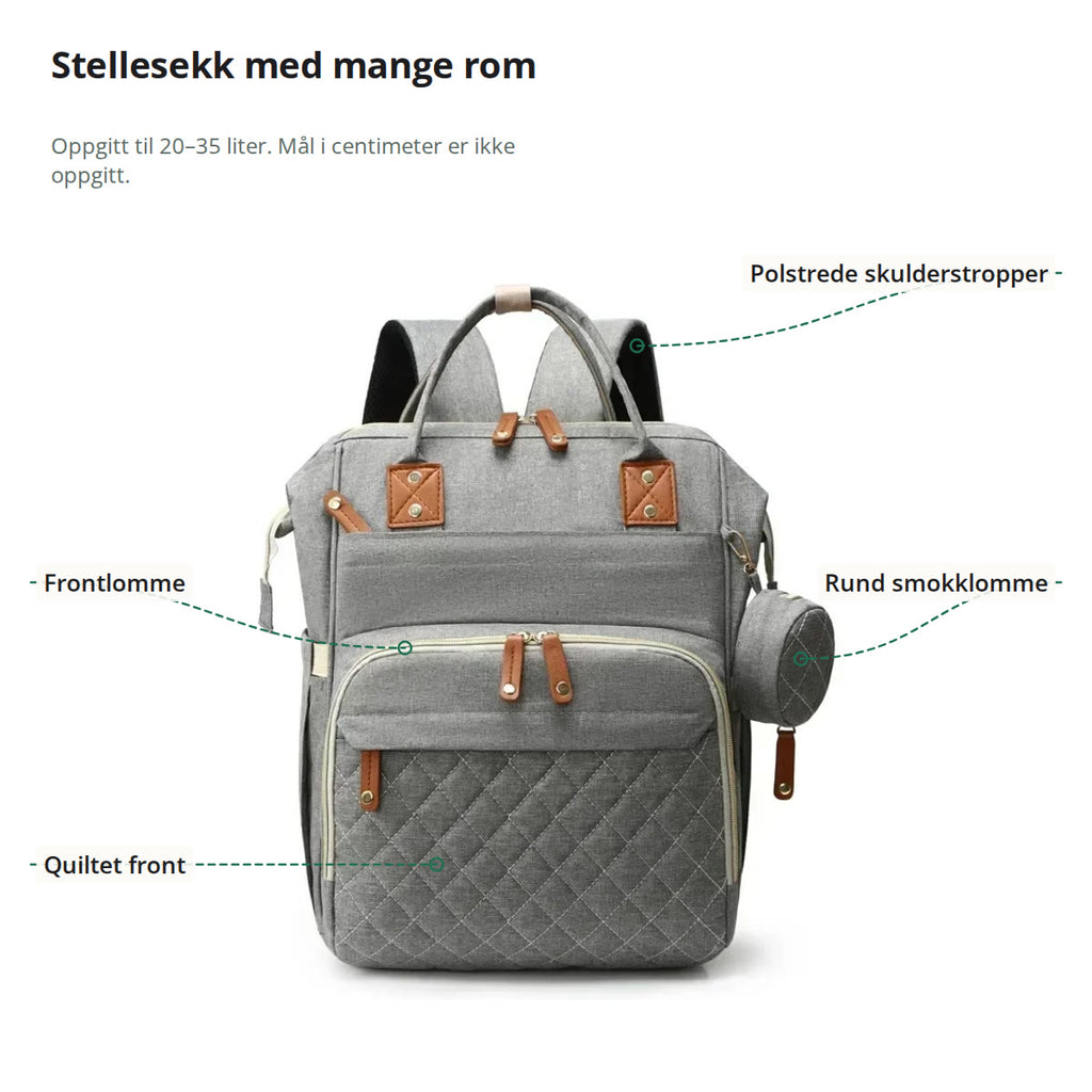 Stellesekken merket med polstrede skulderstropper, rund smokklomme, frontlomme med glidelås og quiltet front