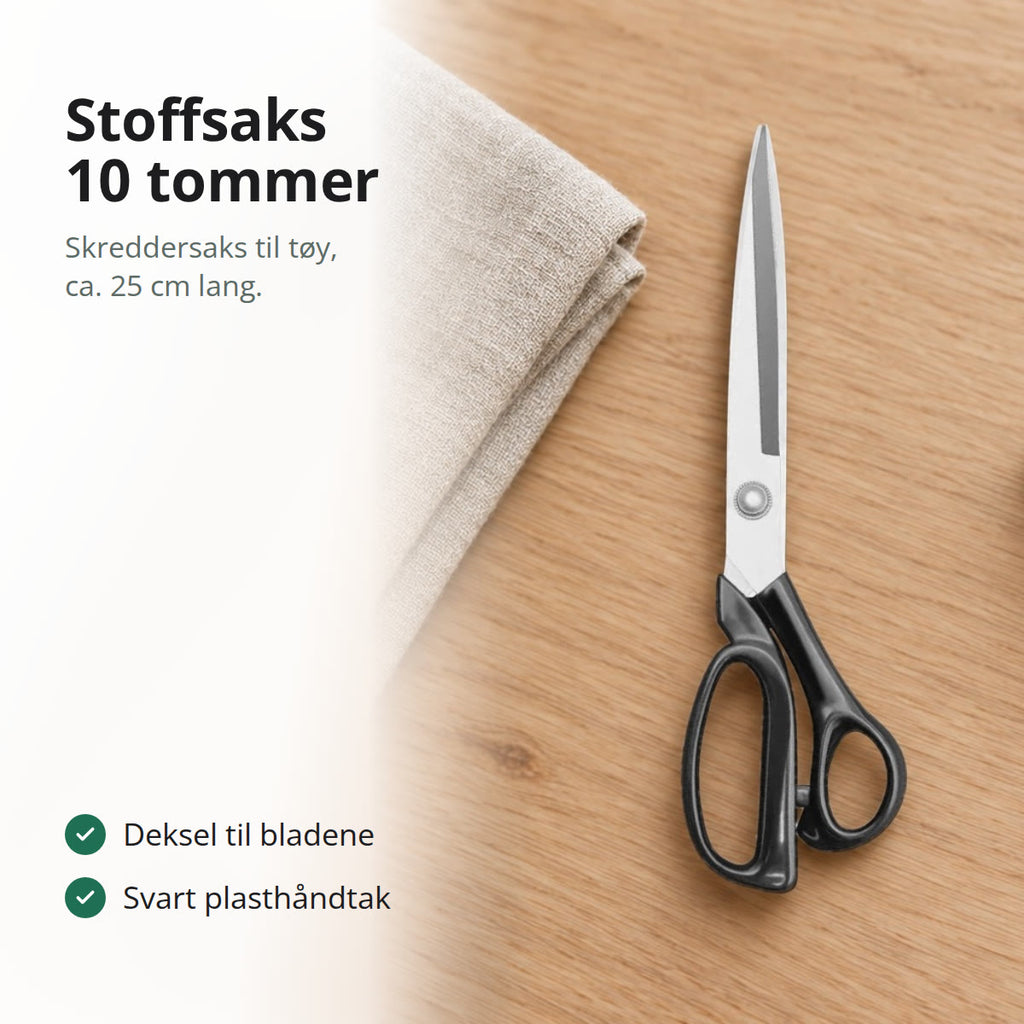 Stoffsaks med lange blad og svart håndtak på et trebord ved siden av et sammenbrettet linstoff