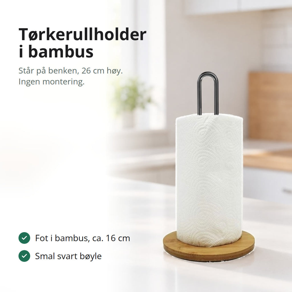 Tørkerullholder med fot i bambus og svart bøyle med tørkerull på en hvit kjøkkenbenk