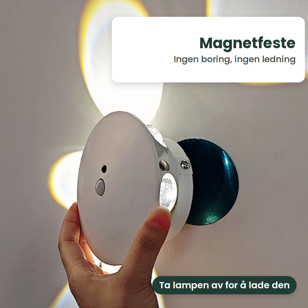 Hånd som tar den hvite lampen av den runde magnetplaten på veggen
